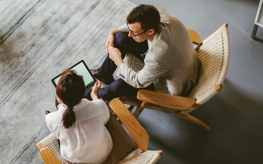 Accountant and business owner reviewing financial information on a laptop during an advisory consultation